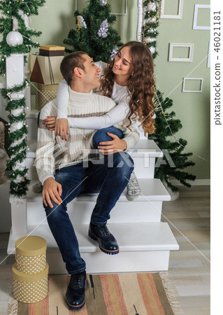 Young man and a young girl are sitting 46021181