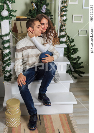 Young man and a young girl are sitting 46021182