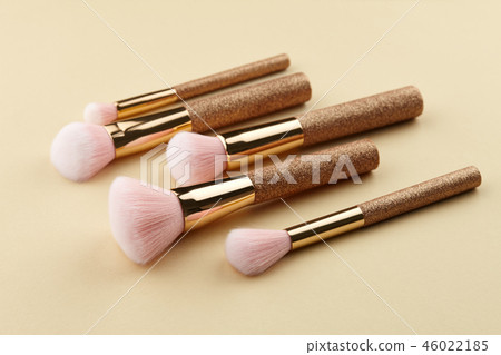 Make up brushes close up on beige background 46022185
