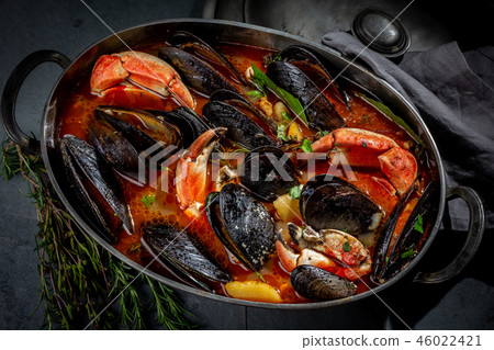 Seafood soup with mussels and crabs in metal pot 46022421