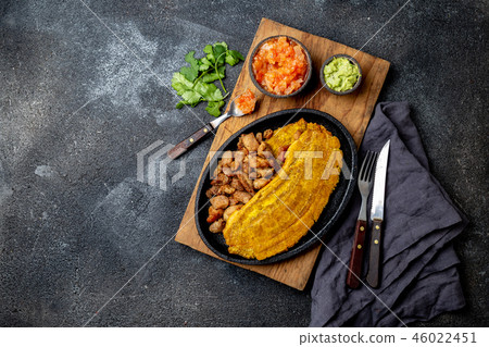 COLOMBIAN CARIBBEAN CENTRAL AMERICAN FOOD. Patacon or toston, fried and flattened whole green 46022451