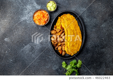 COLOMBIAN CARIBBEAN CENTRAL AMERICAN FOOD. Patacon or toston, fried and flattened whole green 46022463