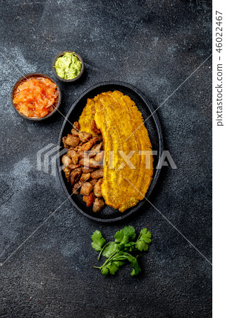 COLOMBIAN CARIBBEAN CENTRAL AMERICAN FOOD. Patacon or toston, fried and flattened whole green 46022467