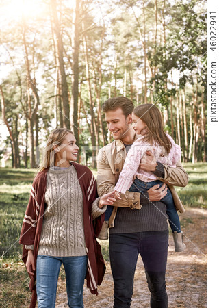 Young parents with little daughter in autumn forest. 46022941