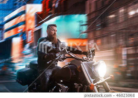 Biker riding on chopper through the night city 46023068