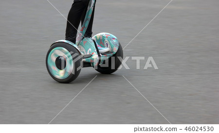 Girl using electric segway outdoors. 46024530