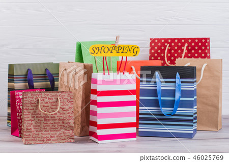 Assorted paper shopping bags background. 46025769