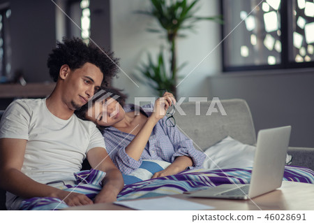 Worried young couple discussing bills at home 46028691