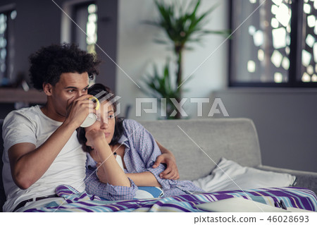 Young couple watching a movie on their laptop in bed Young couple watching a movie on their laptop in bed 46028693
