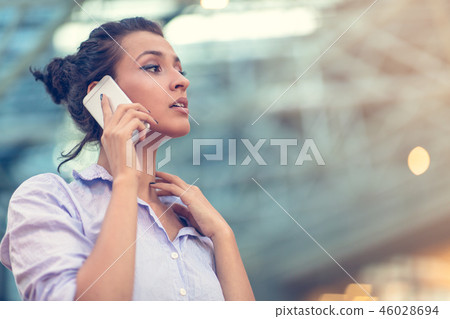 Young woman busy with calling, chatting on the cell phone side view portrait. Young woman busy with calling, chatting on the cell phone side view portrait. 46028694
