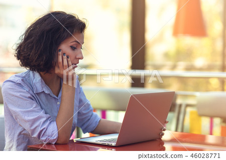 Stressed hipster businesswoman working on laptop in her office 46028771