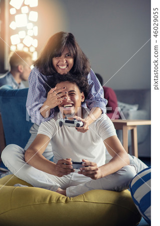 Couple playing video games at modern startup office Couple playing video games at modern startup office 46029055
