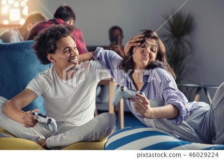Couple playing video games at modern startup office 46029224