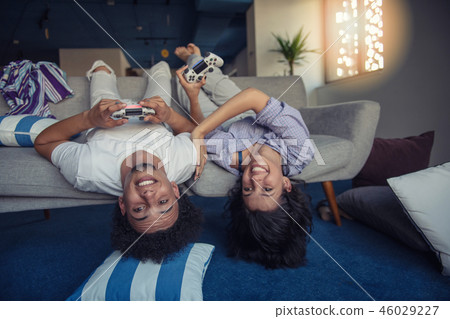 Young couple enjoying playing video games together. 46029227