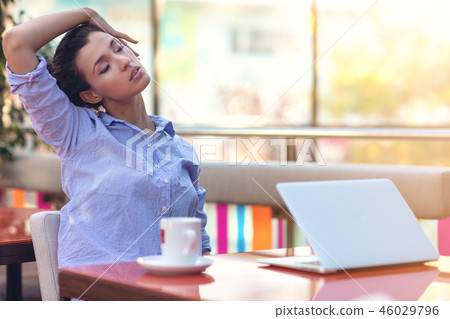 Stressed hipster businesswoman working on laptop in her office 46029796