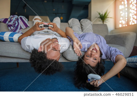 Young couple enjoying playing video games together. Young couple enjoying playing video games together. 46029851
