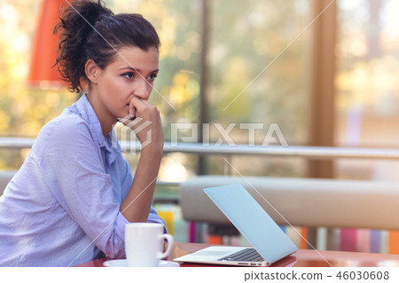 Stressed hipster businesswoman working on laptop in her office Stressed hipster businesswoman working on laptop in her office 46030608