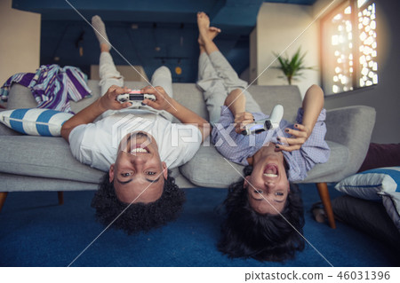 Young couple enjoying playing video games together. 46031396