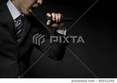 Man holding a microphone and emphasizing Man holding a microphone and emphasizing 46032248