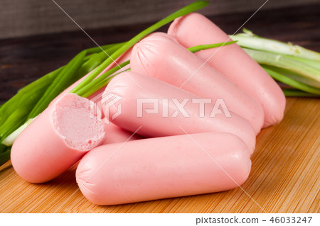 heap of Sausage with green onion on a wooden background heap of Sausage with green onion on a wooden background 46033247