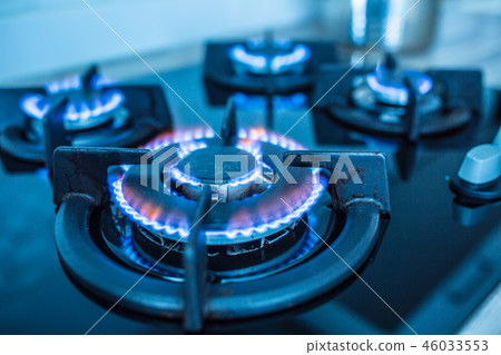 Close-up kitchen stove cook with blue flames. Close-up kitchen stove cook with blue flames. 46033553