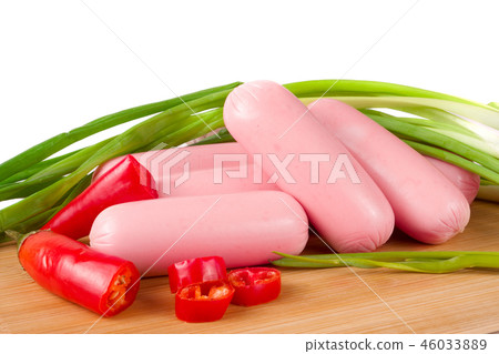 sausages with green onions and chilli on a cutting board isolated  white background closeup 46033889