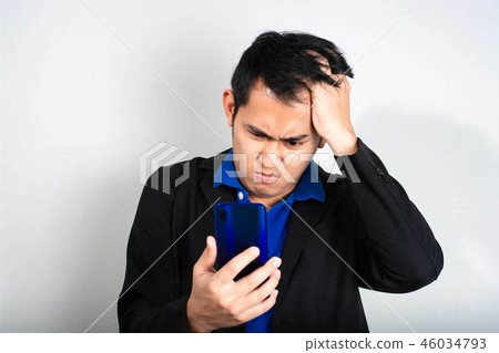 Furious businessman outraged on the phone 46034793