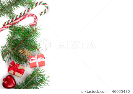 Christmas Frame of Fir tree branch with candy canes and boxes isolated on white background with copy Christmas Frame of Fir tree branch with candy canes and boxes isolated on white background with copy 46035480