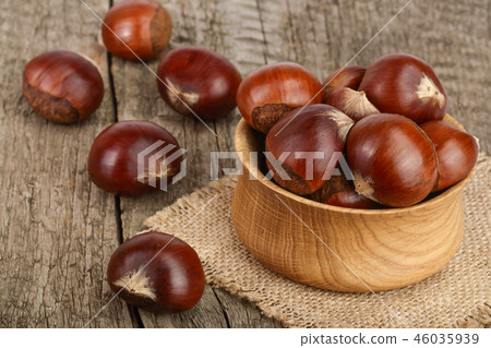chestnut in wooden bowl on old wooden background 46035939