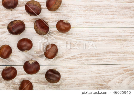chestnut on white wooden background with copy space for your text. Top view. Flat lay. chestnut on white wooden background with copy space for your text. Top view. Flat lay. 46035940