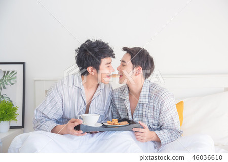 homosexual couple having breakfast in bed  46036610