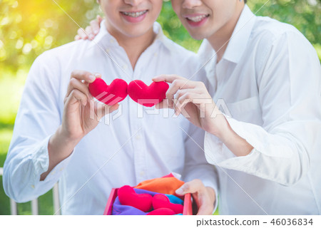 homosexual couple holding red color heart shape  46036834