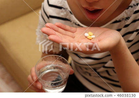 Woman taking medicine 46038130