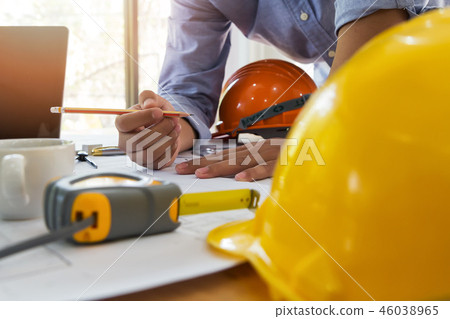 Architect or engineer working on blueprint. Architect or engineer working on blueprint. 46038965