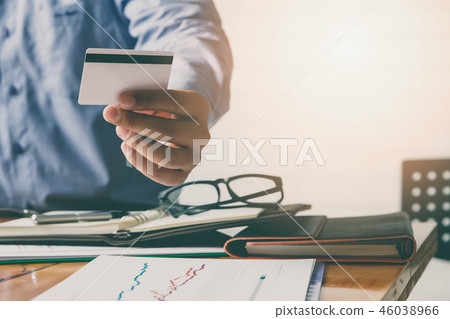 Businessman holding credit card and using laptop. Businessman holding credit card and using laptop. 46038966