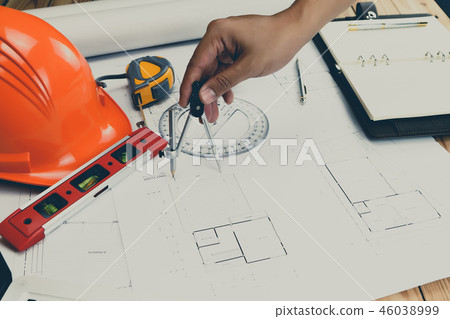 An architect or engineer working on blueprint 46038999