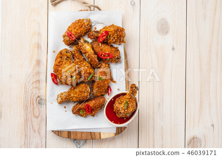 Chicken nuggets with sauce and pepper on a white board. Copy space. Chicken nuggets with sauce and pepper on a white board. Copy space. 46039171
