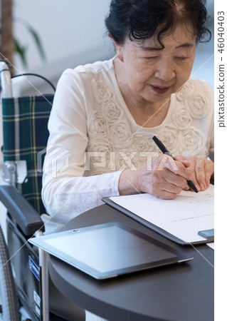 Senior image Senior woman signing paperwork Senior image Senior woman signing paperwork 46040403
