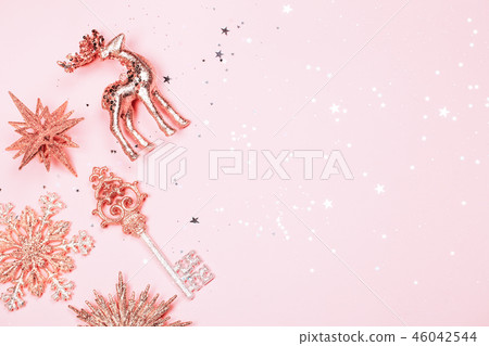 Golden beautiful sparkling christmas decorative toys on pastel pink background. Golden beautiful sparkling christmas decorative toys on pastel pink background. 46042544
