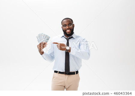 young cheerful black businessman holding and pointing at money isolated on white young cheerful black businessman holding and pointing at money isolated on white 46043364