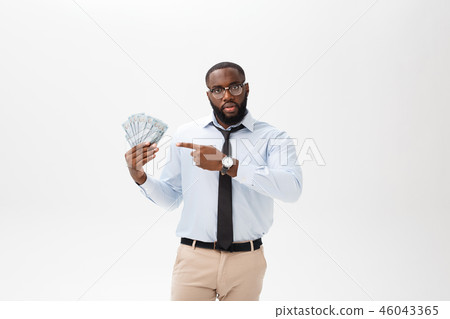 African American businessman holding Cash and serious looking at camera. Indoor, isolated on gray African American businessman holding Cash and serious looking at camera. Indoor, isolated on gray 46043365