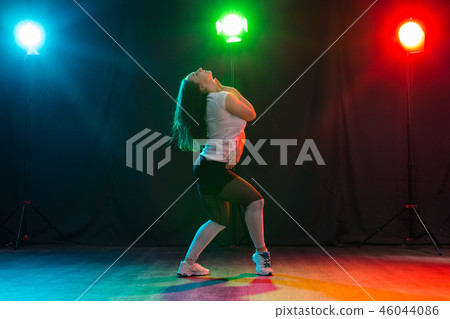 Hip-hop, jazz-funk, tecktonik, waacking, trance and street dances concept - Pretty woman dancing Hip-hop, jazz-funk, tecktonik, waacking, trance and street dances concept - Pretty woman dancing 46044086