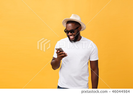 Cheerful African American man in white shirt using mobile phone application. happy dark skinned Cheerful African American man in white shirt using mobile phone application. happy dark skinned 46044984