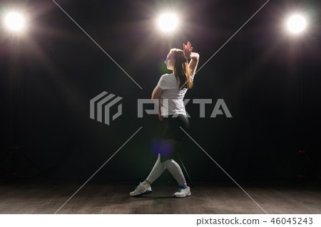 Hip-hop, jazz-funk, tecktonik, waacking, trance and street dances concept - Young woman dancing jazz 46045243