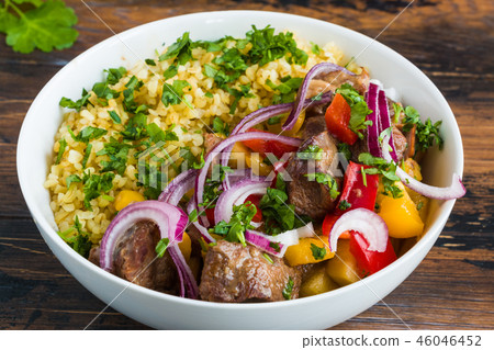 Big white bowl with beef cooked with vegetables 46046452