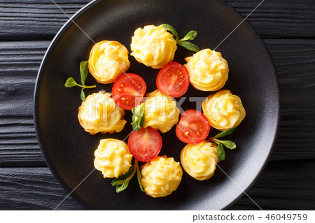 Duchess potatoes served with mint and tomatoes Duchess potatoes served with mint and tomatoes 46049759