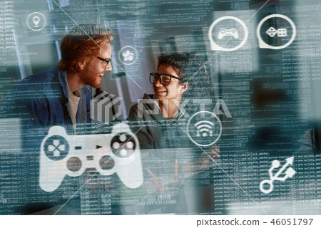 Young indian woman game developer and red haired man are laughting about idea Young indian woman game developer and red haired man are laughting about idea 46051797