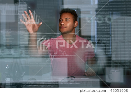 Young concentrated indian data analyst looking over the data 46051908