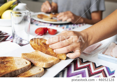 man and woman preparing breakfast man and woman preparing breakfast 46052128