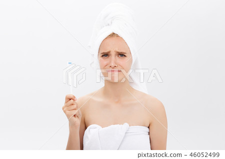 Disappointed young beautiful model sad with her skin on white background. Disappointed young beautiful model sad with her skin on white background. 46052499